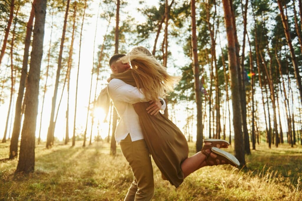 Feeling passion. Happy couple is outdoors in the forest at daytime
