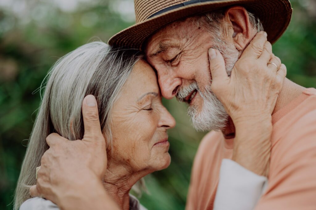 Portrait of senior couple in love, standing outdoor in nature.